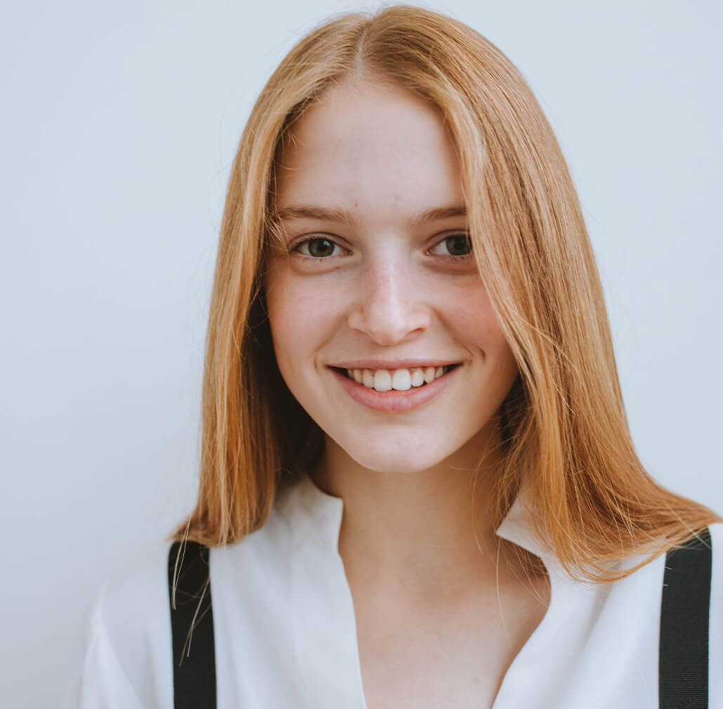 a girl showing off her teeth with a smile